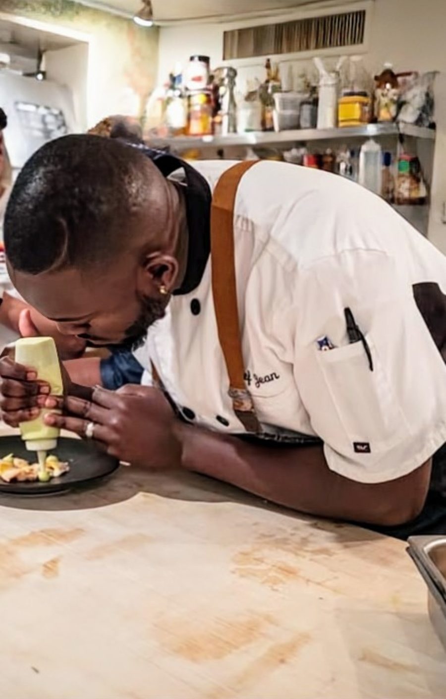 Chef Jean Lorestil plating at an event