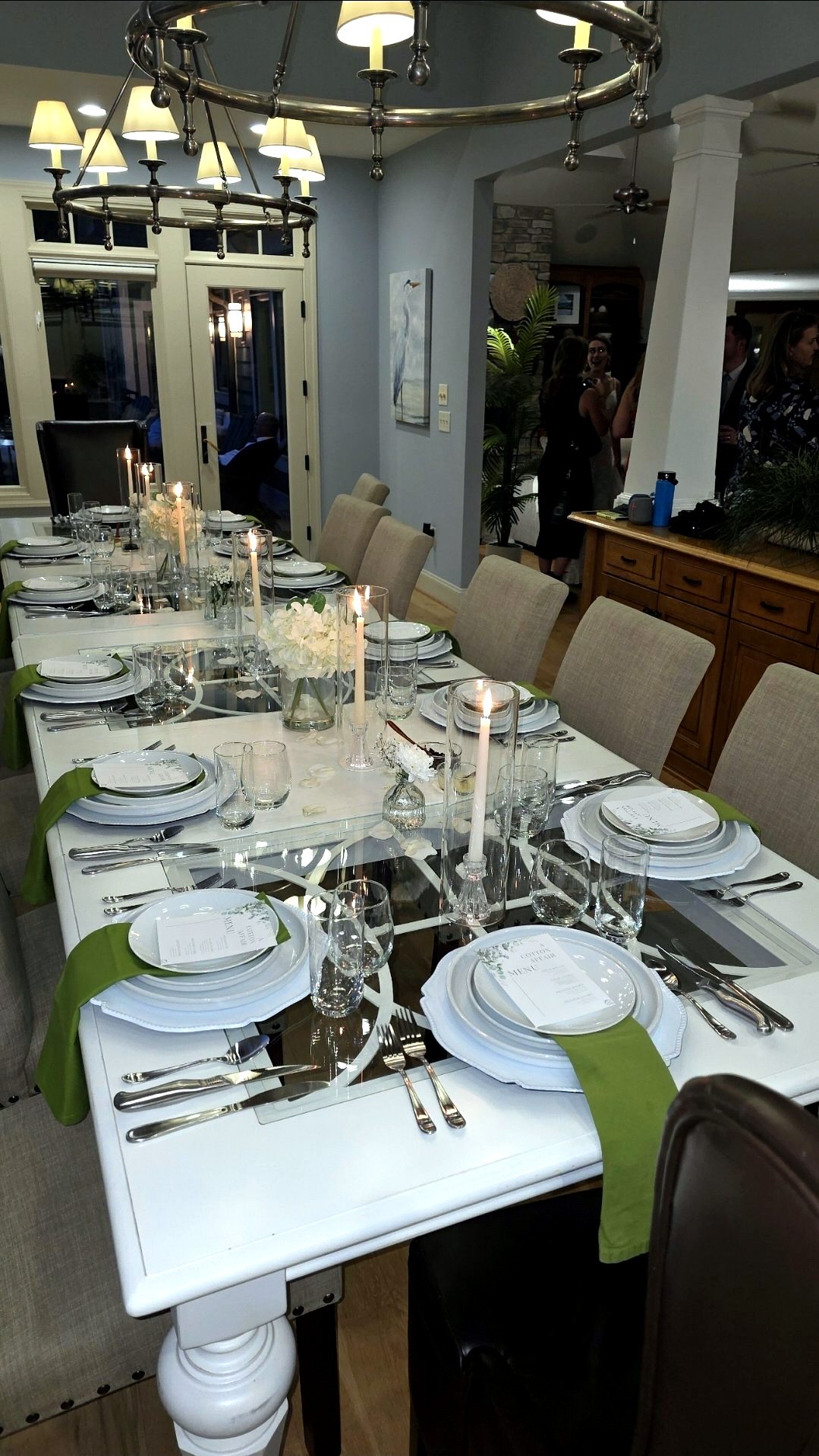 Candlelit dinner table with printed menus by Chef Jean Lorestil
