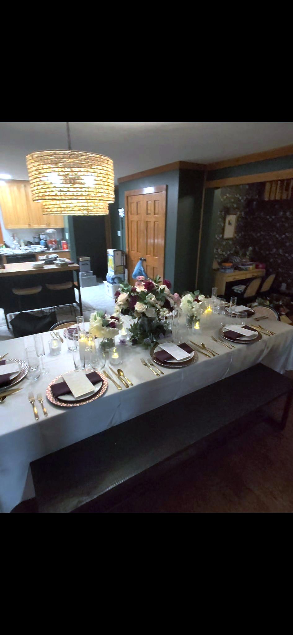 Candlelit private dinner table with burgundy napkins set by Chef Jean Lorestil